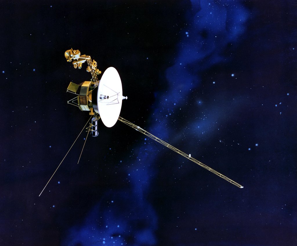 An illustration of NASA’s Voyager 2 spacecraft: a large, white dish-shaped high-gain antenna pointed toward the right, with long instrument booms and scientific sensors extending from its body, against a black and blue background with visible stars.