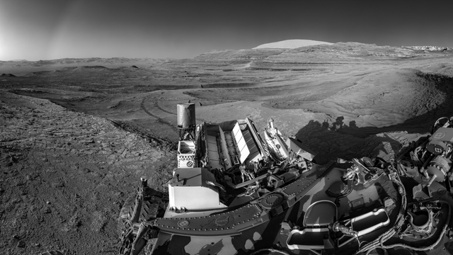 This view of tracks trailing behind NASA's Curiosity was captured while the rover simultaneously relayed data to a Mars orbiter.