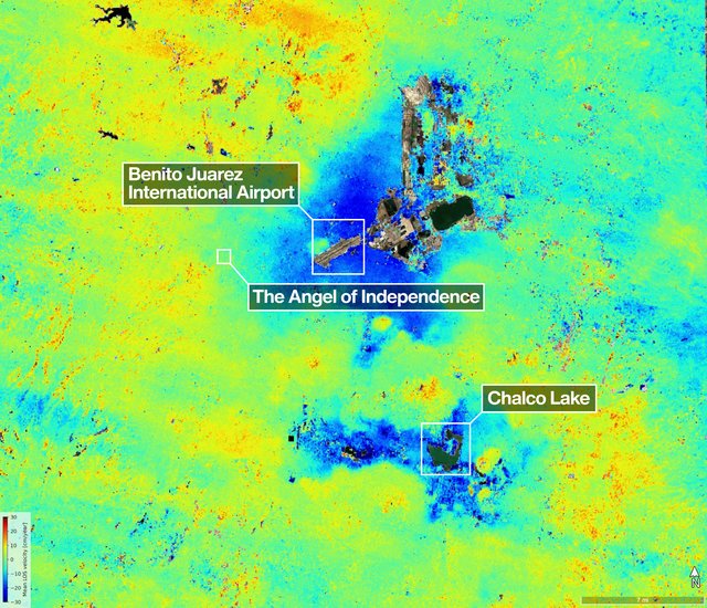 A satellite image of the Mexico City area shows land subsidence via a vibrant heat map, with dark blue patches indicating the highest rates of sinking contrasted against more stable terrain indicated in yellow and green.