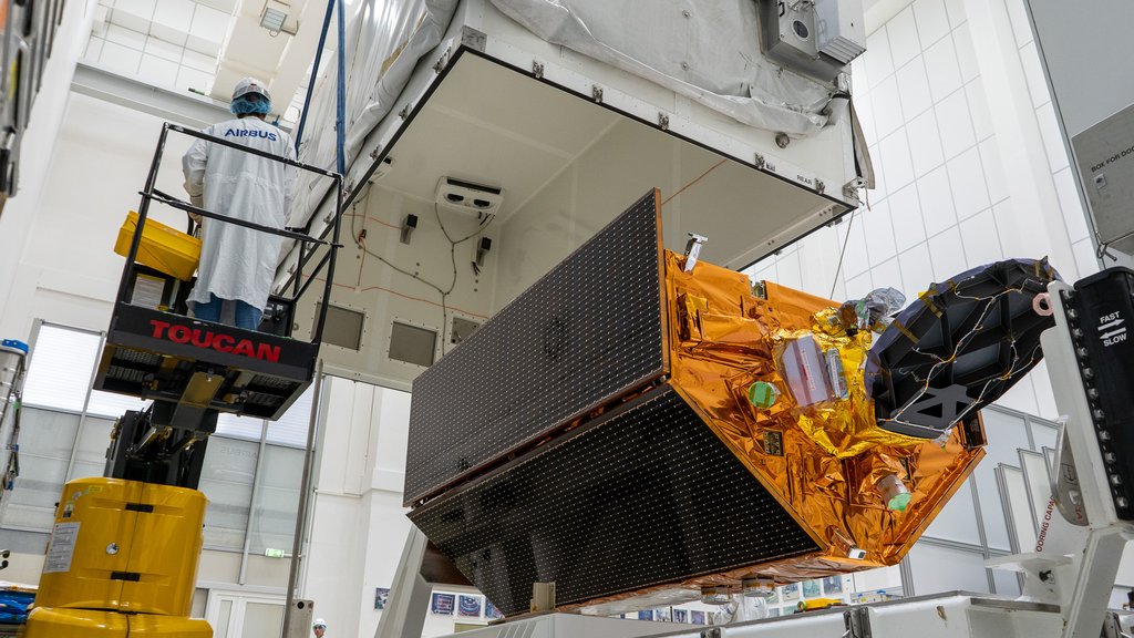 Workers inside a clean room in Germany lowered a shipping container over the Sentinel-6B satellite in preparation for the spacecraft’s journey from Europe to its launch site at Vandenberg Space Force Base in California.