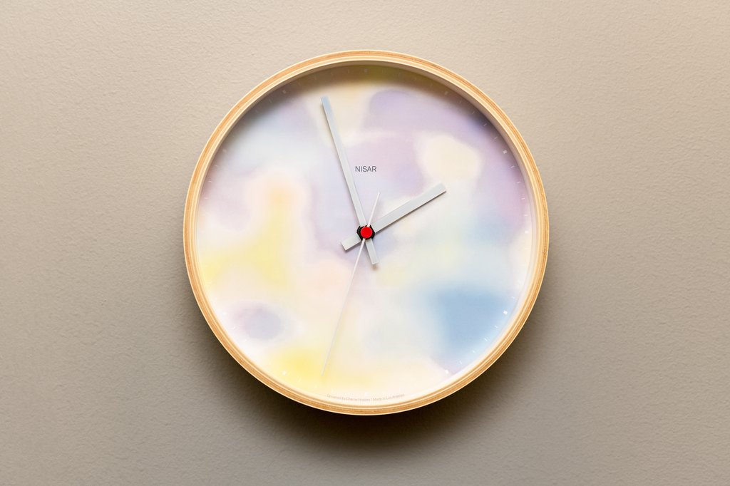 clock with blurry pink blue and yellow faceplate