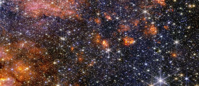 Stars, gas and cosmic dust in the Sagittarius B2 molecular cloud glow in  near-infrared light