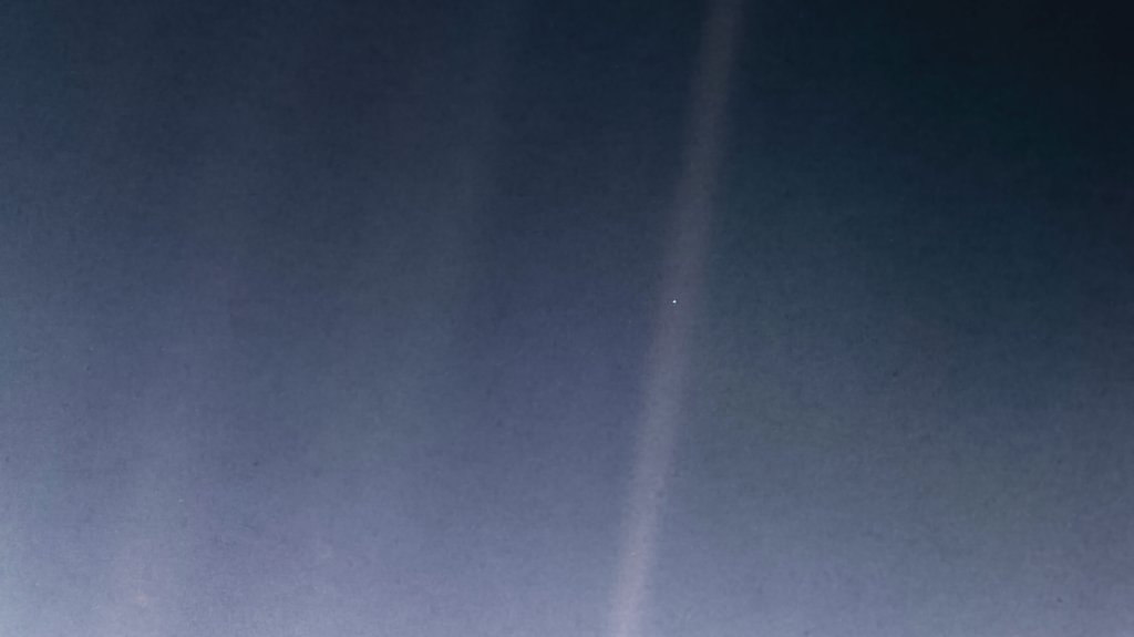 “This is where we live — on a blue dot,” Sagan said, describing this Voyager image in which Earth appears as a pixel-size speck.