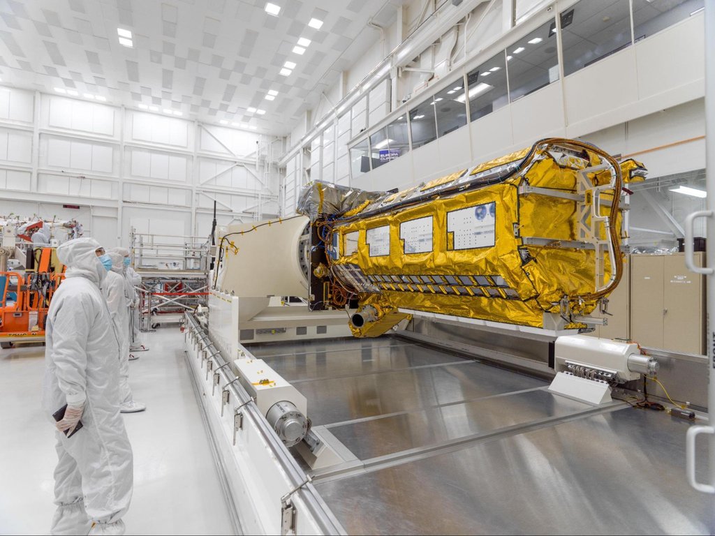 Gold-colored satellite hardware in NASA cleanroom