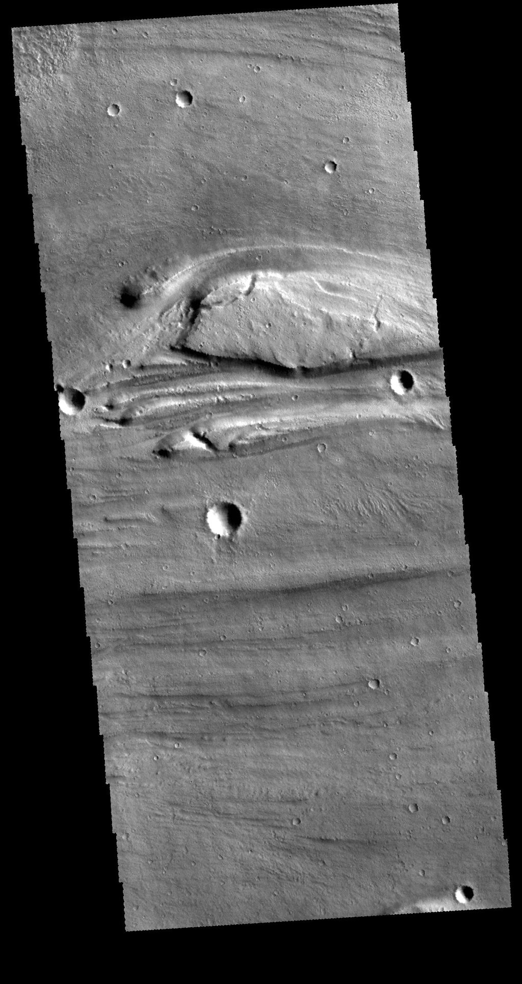 This image from NASA's 2001 Mars Odyssey spacecraft shows a very small portion of Kasei Valles. There are several streamlined islands near the center of the image.