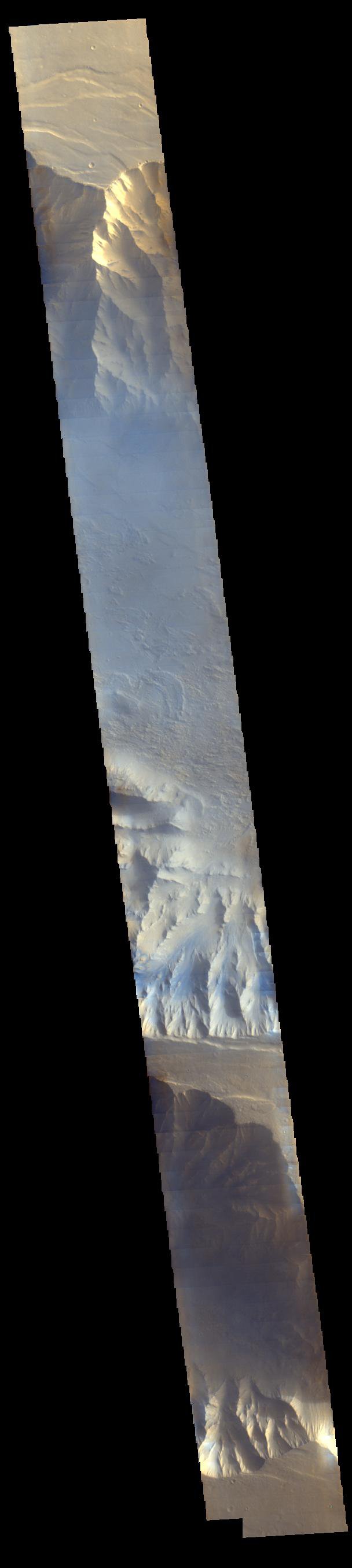 Light blue clouds fill Coprates Chasma on Mars, part of Valles Marineris, the vast 'Grand Canyon of Mars.' The clouds are mostly ice crystals and they appear blue in color in this image from NASA's Mars Odyssey.