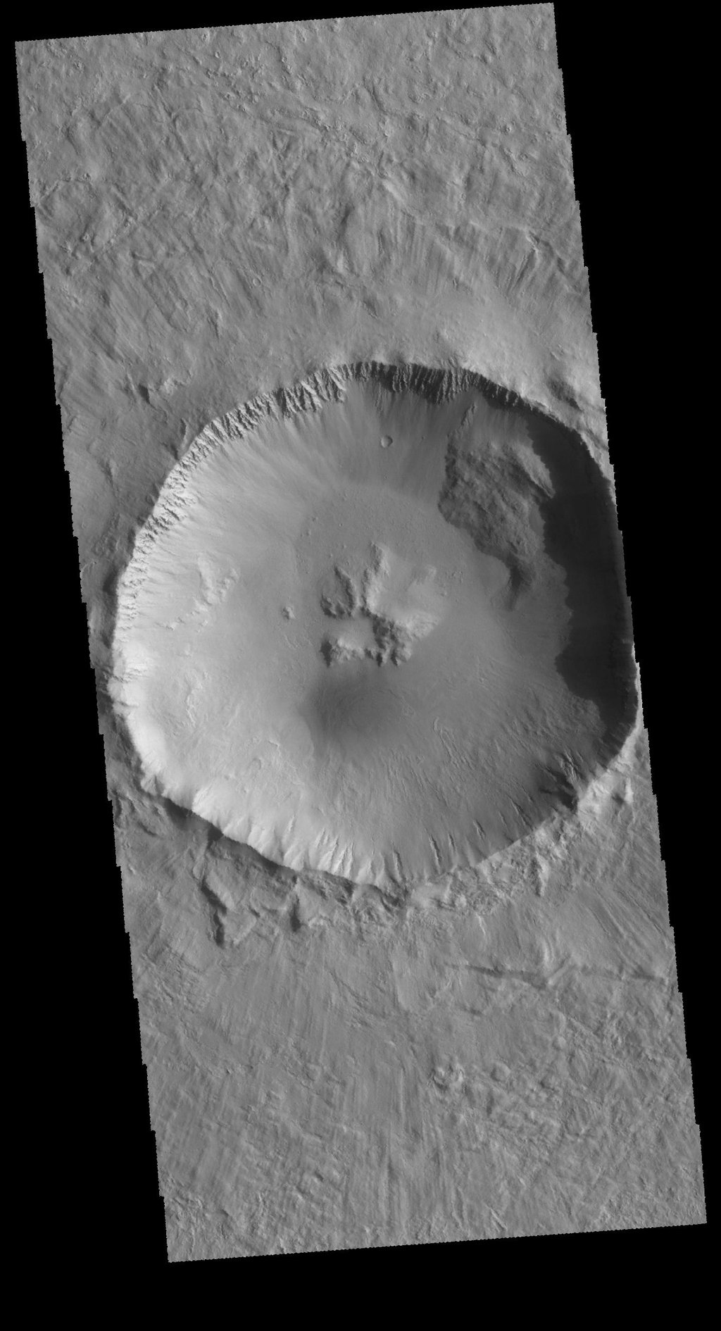 This image captured by NASA's 2001 Mars Odyssey spacecraft shows an unnamed crater located northwest of Elysium Mons. This crater contains a central pit, which formed at the time of impact.