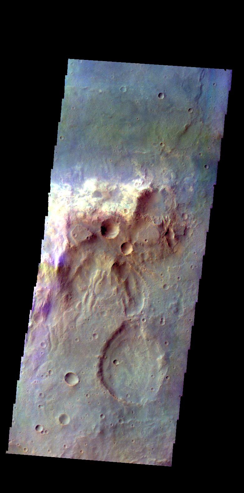 The THEMIS camera contains 5 filters. The data from different filters can be combined in multiple ways to create a false color image. This image from NASA's 2001 Mars Odyssey spacecraft shows a hill in Tyrrhena Terra.