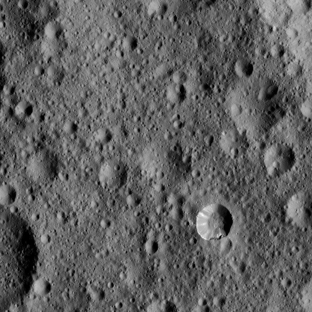 This view from NASA's Dawn spacecraft shows cratered terrain typical of Ceres, with a small bright crater highlighting the scene at lower right.