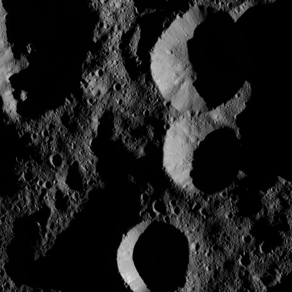 NASA's Dawn spacecraft obtained this view of shadowed craters near Ceres' north pole at a distance of about 240 miles (385 kilometers) above the surface on May 28, 2016.