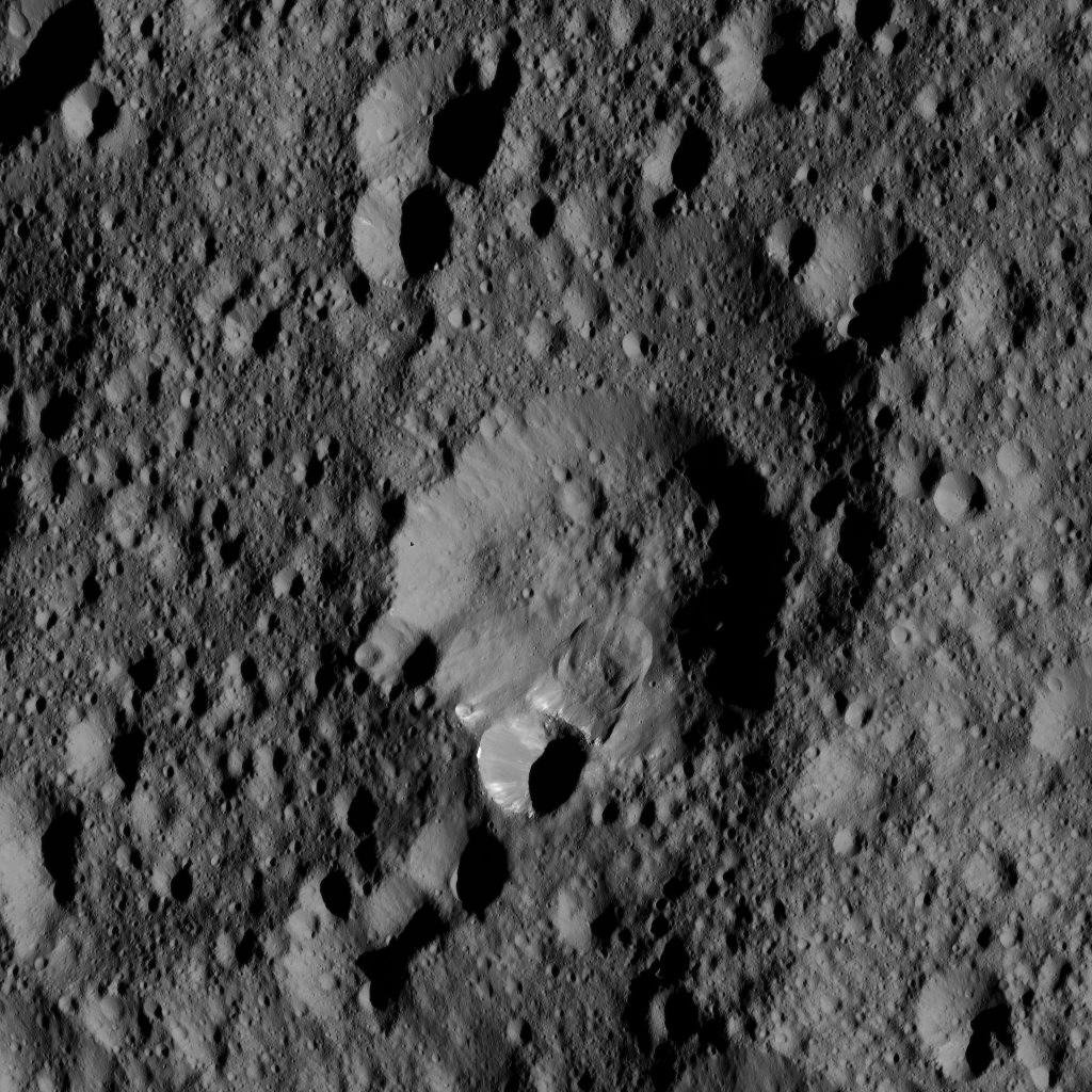 An area along the rim of the crater at the center of this view from NASA's Dawn spacecraft, has collapsed, producing a lobe-shaped feature where the material settled.