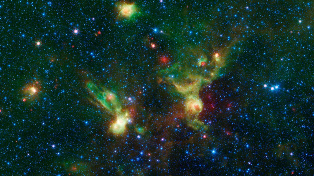 These nebulae seen by NASA's Spitzer Space Telescope, display two regions of star formation that are hidden behind a haze of dust when viewed in visible light, known officially y their catalog numbers, IRAS 19340+2016 and IRAS19343+2026.