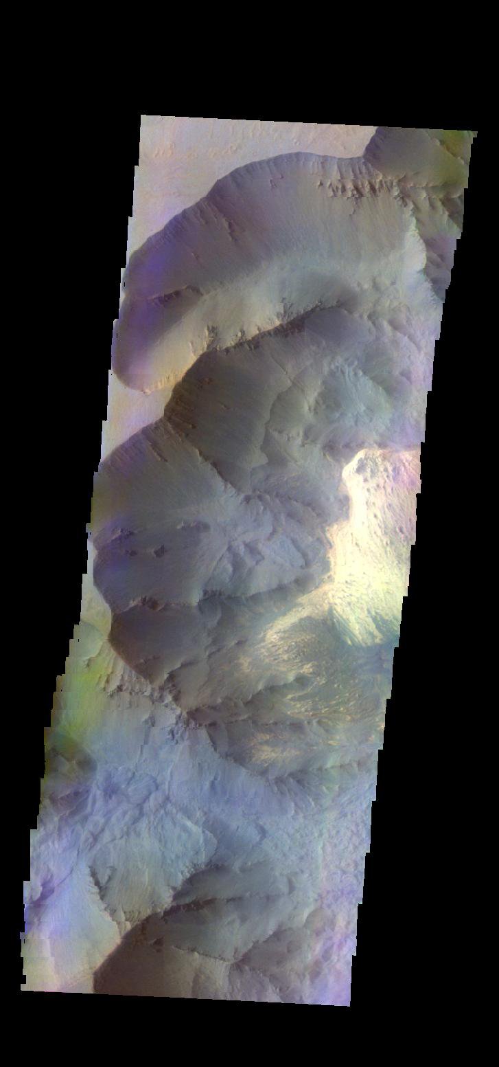 The THEMIS camera contains 5 filters. The data from different filters can be combined in multiple ways to create a false color image. This image from NASA's 2001 Mars Odyssey spacecraft shows part of Juventae Chasma.