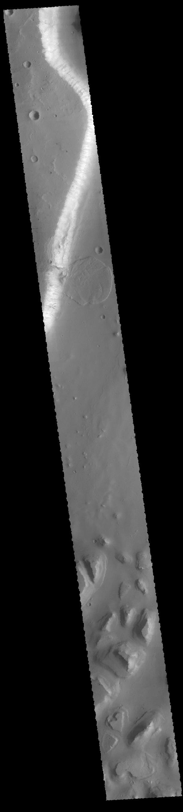 This image captured by NASA's 2001 Mars Odyssey spacecraft shows a landslide deposit from the cliffside along Tiu Valles.