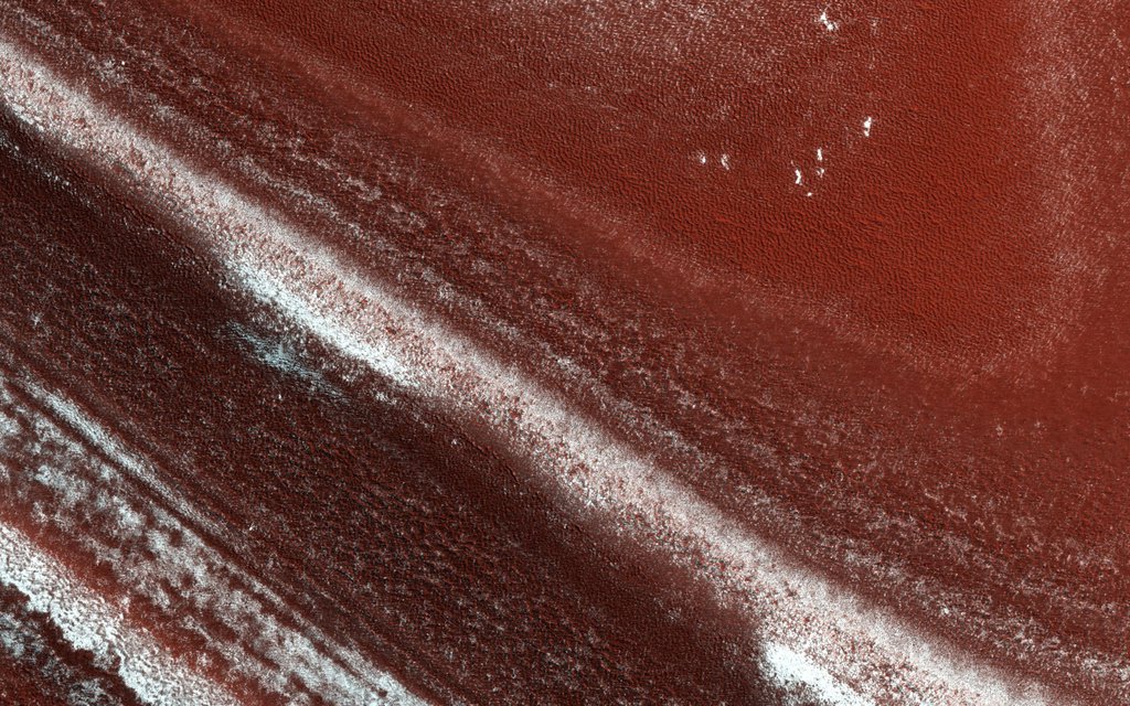 At the edge of Mars' permanent North Polar cap, NASA's Mars Reconnaissance Orbiter sees an exposure of the internal layers, each with a different mix of water ice, dust and dirt.
