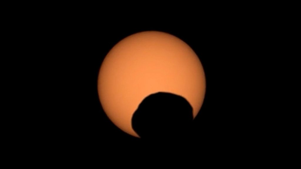 NASAs Perseverance rover captured the silhouette of the Martian moon Phobos as it passed in front of the Sun on Sept. 30, 2024.