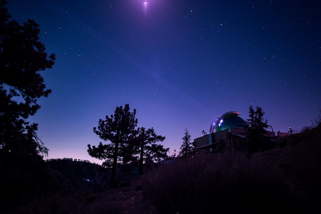 In this infrared photograph, the Optical Communications Telescope Laboratory at JPLs Table Mountain Facility beams its laser beacon to the DSOC flight laser transceiver aboard NASAs Psyche spacecraft.