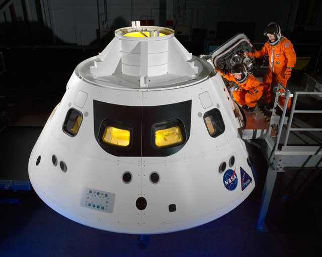 Orion crew members step into the capsule